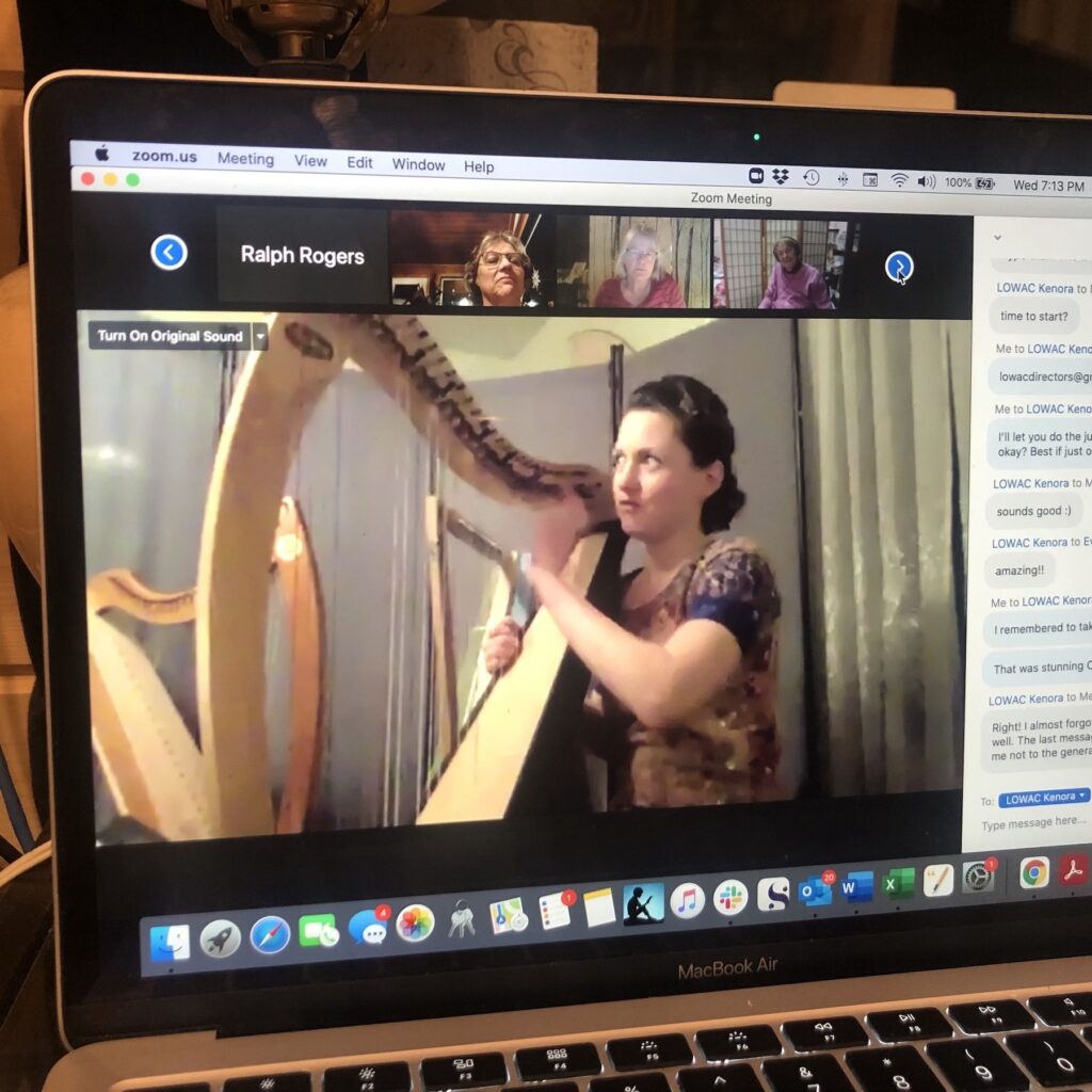 Olivia Whiddon playing a harp and singing