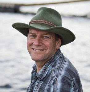 Tim Martin wearing a cowboy hat and smiling at camera