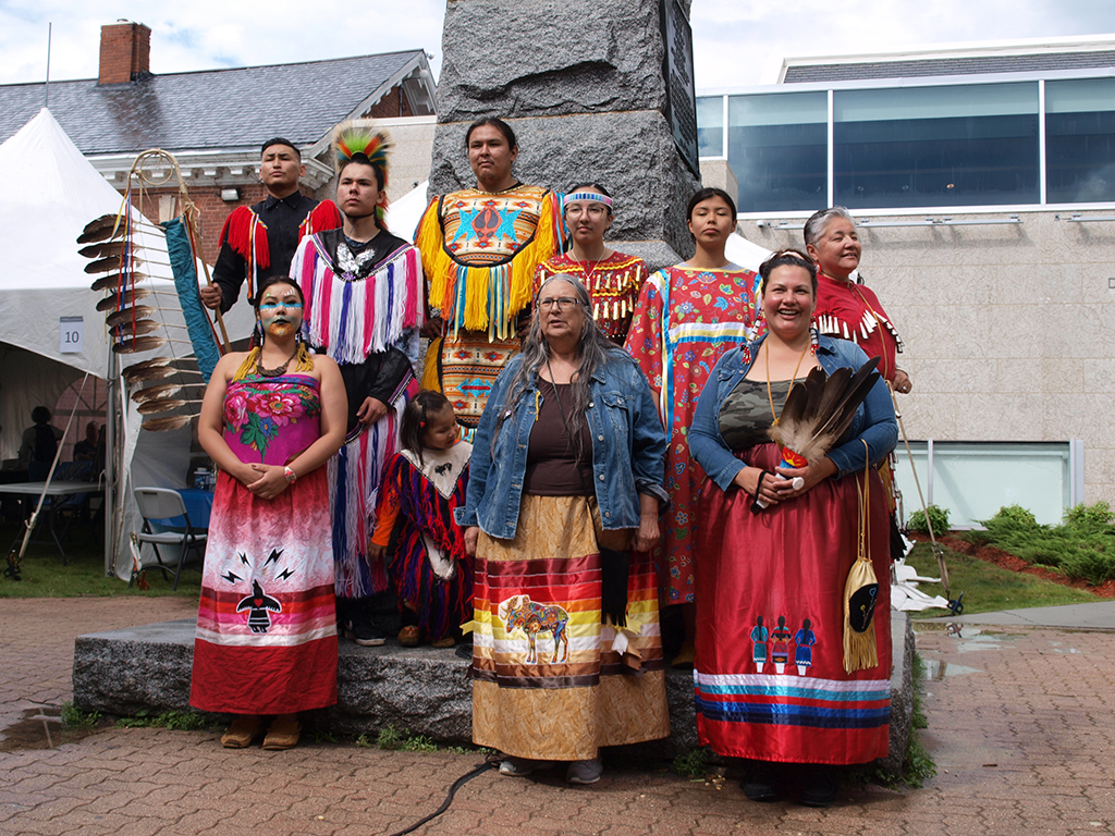 Group of Indigenous people in regalia.