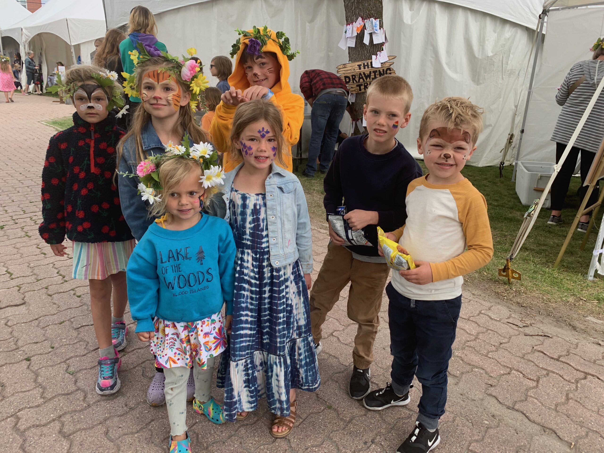 7 young children with their faces painted at ArtsFest