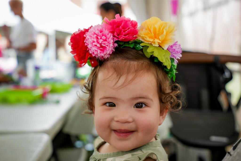 Baby wearing a flower crown smiling at camera